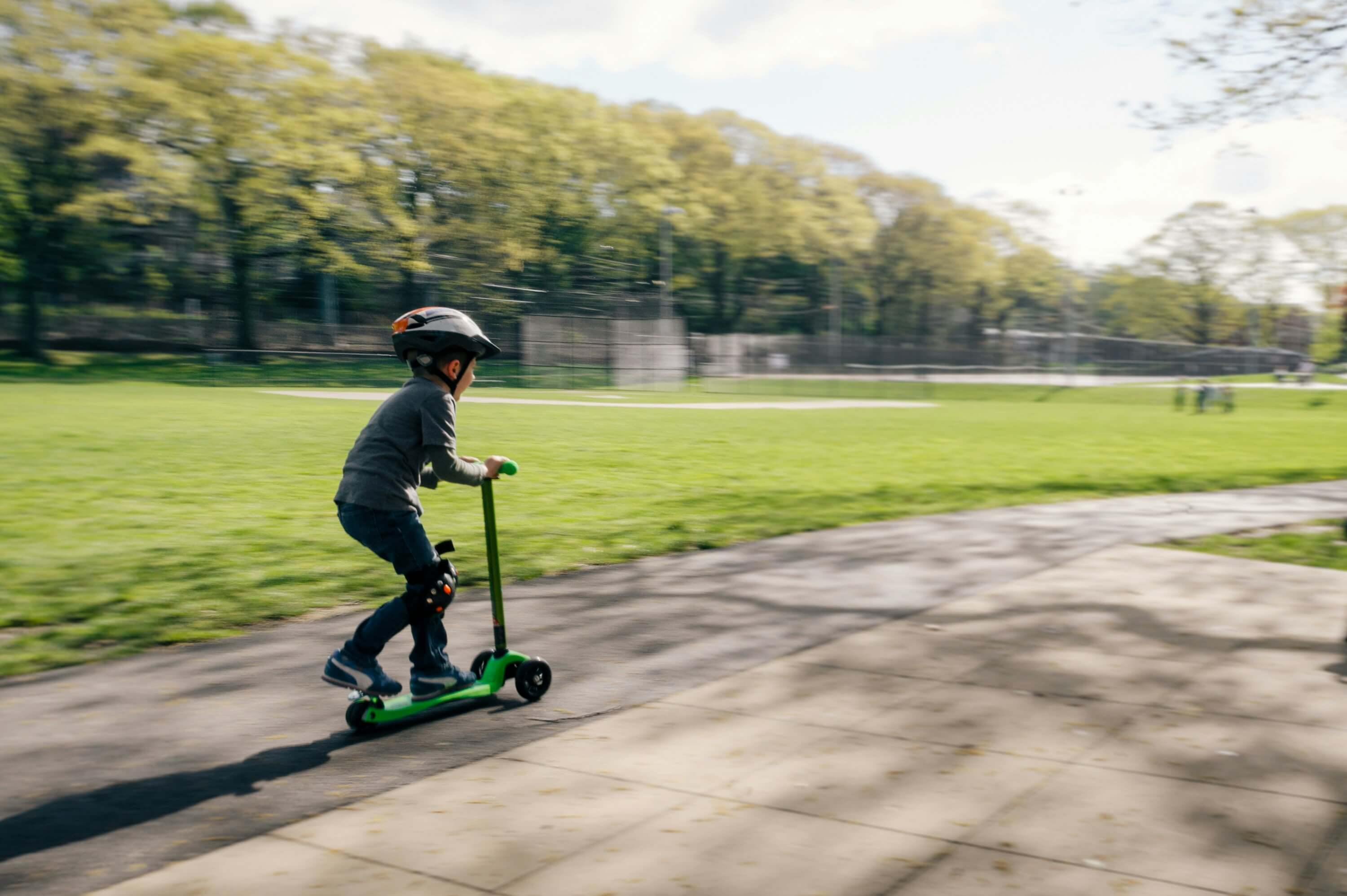 公園でキックボードに乗る男の子